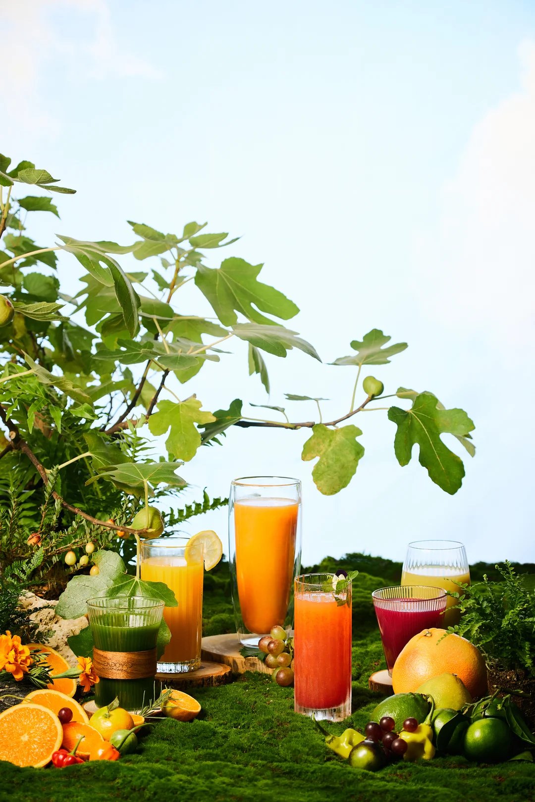 Hurom H70 w jasnej kuchni z gotowym sokiem i świeżymi warzywami